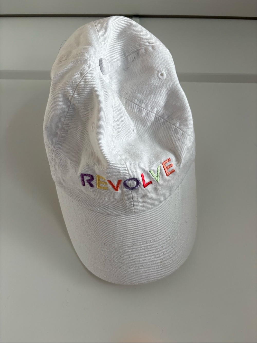REVOLVE White Cap with Rainbow Embroidered Logo